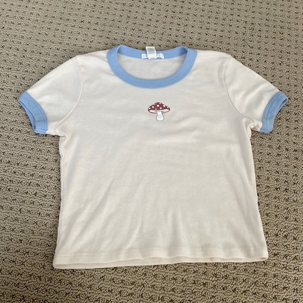 Cute tee shirt with small mushroom.